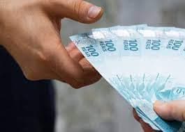 Empréstimo: notas de cem reais sendo entregues