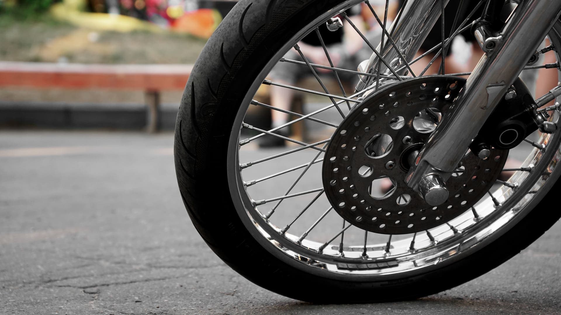 Empréstimo com garantia: uma moto está parada na rua e, na imagem, é possível ver a roda e pneu dianteiros.