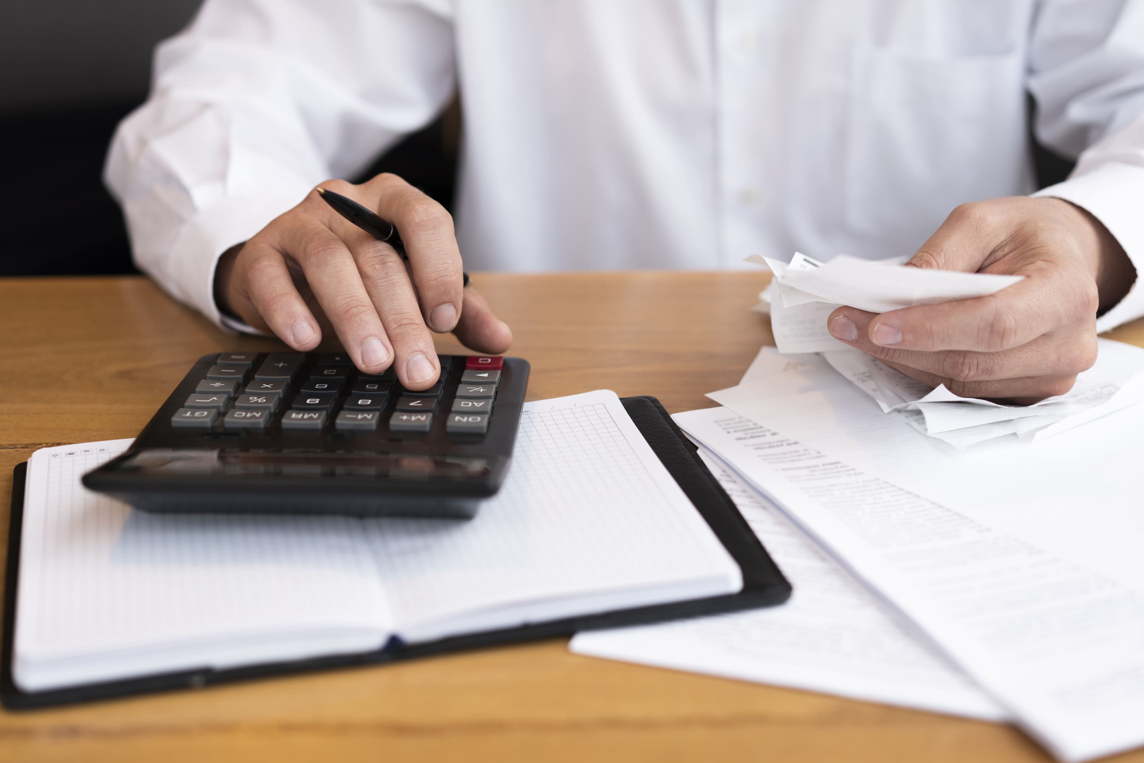 homem fazendo cálculos (declarar financiamento de imóvel no IR)