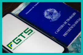 FGTS: celular mostrando o logo do FGTS, posicionado ao lado de uma carteira de trabalho